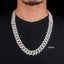 Man wearing an 18mm iced out Cuban link chain necklace over black shirt