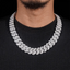 close up of iced out cuban link chain necklace on man wearing black sweater