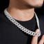 Close-up of a man wearing a thick iced-out Cuban link chain necklace