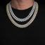 Two iced out Cuban link chain necklaces in silver and gold worn over a black shirt.