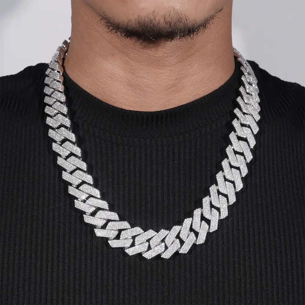 iced out Cuban link chain necklace with large silver links on a person wearing black shirt