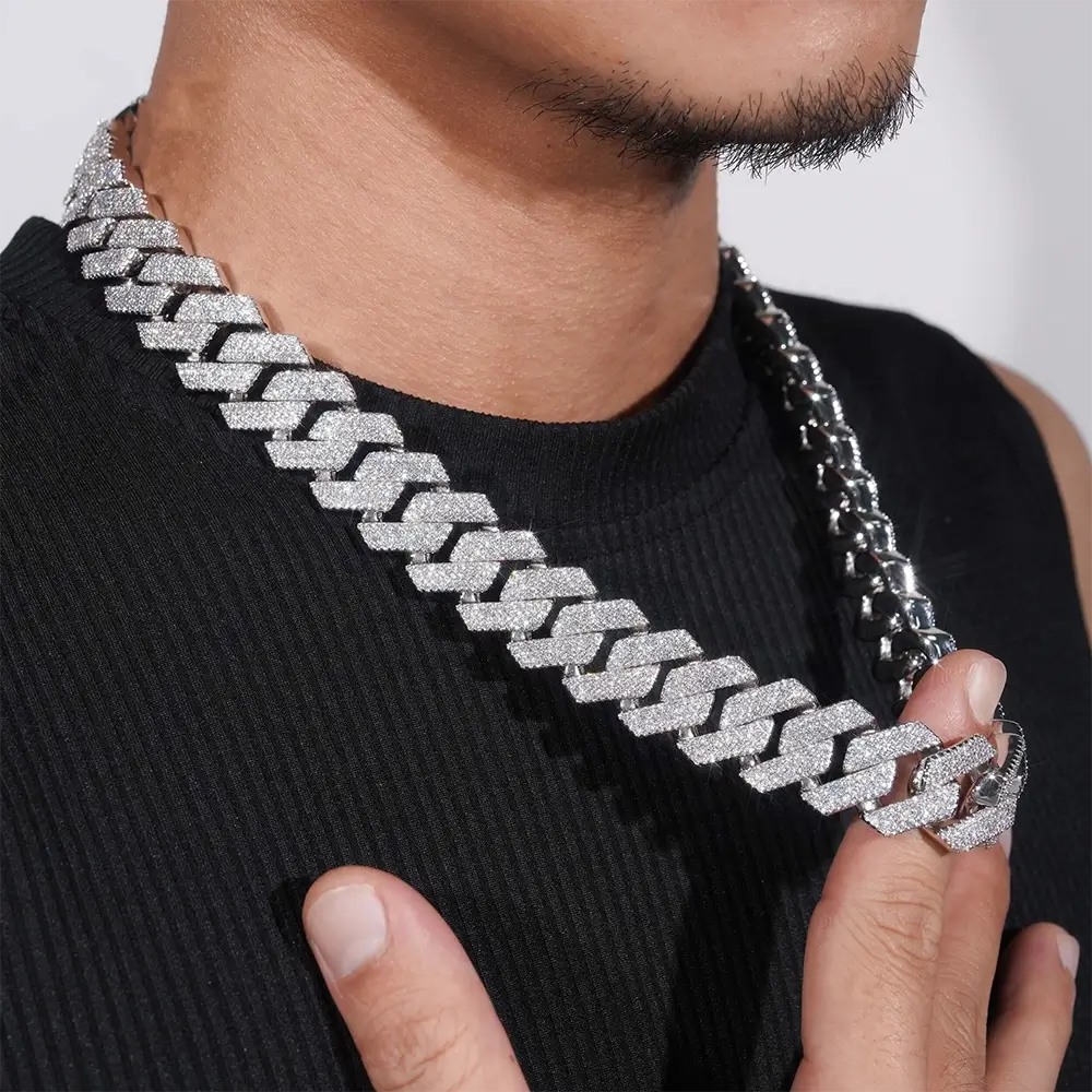 Close-up of man wearing iced out Cuban link chain necklace, hip hop jewelry style Secondary image