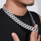 Close-up of man wearing iced out Cuban link chain necklace, hip hop jewelry style