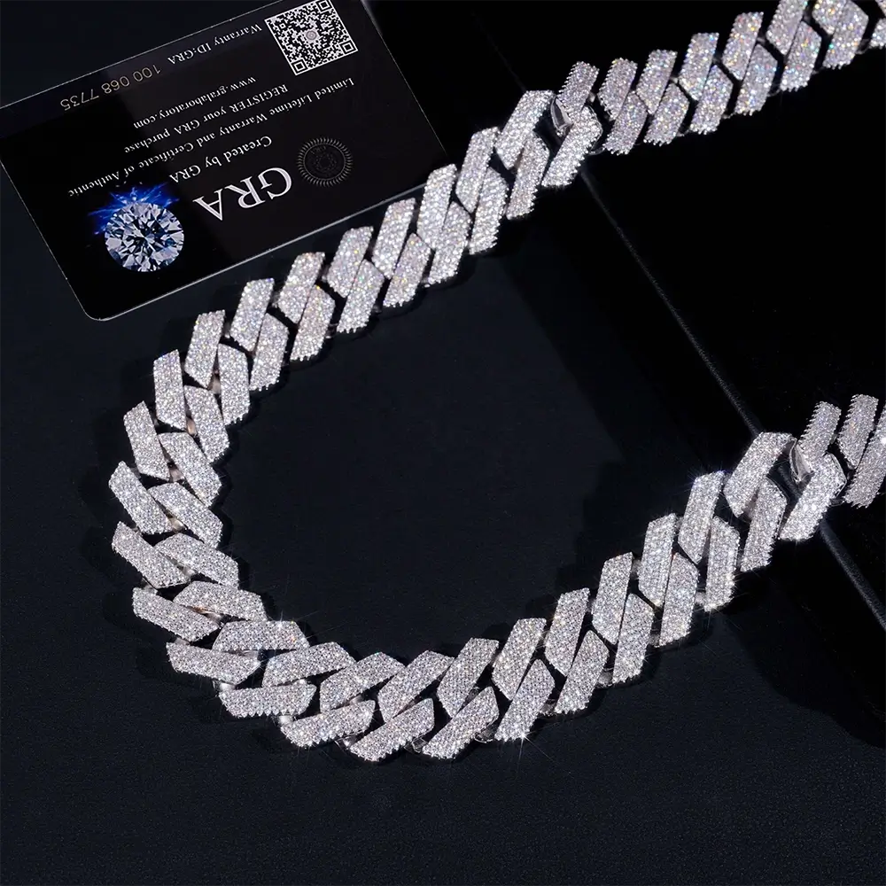 Iced out Cuban link chain necklace with sparkling stones on dark background