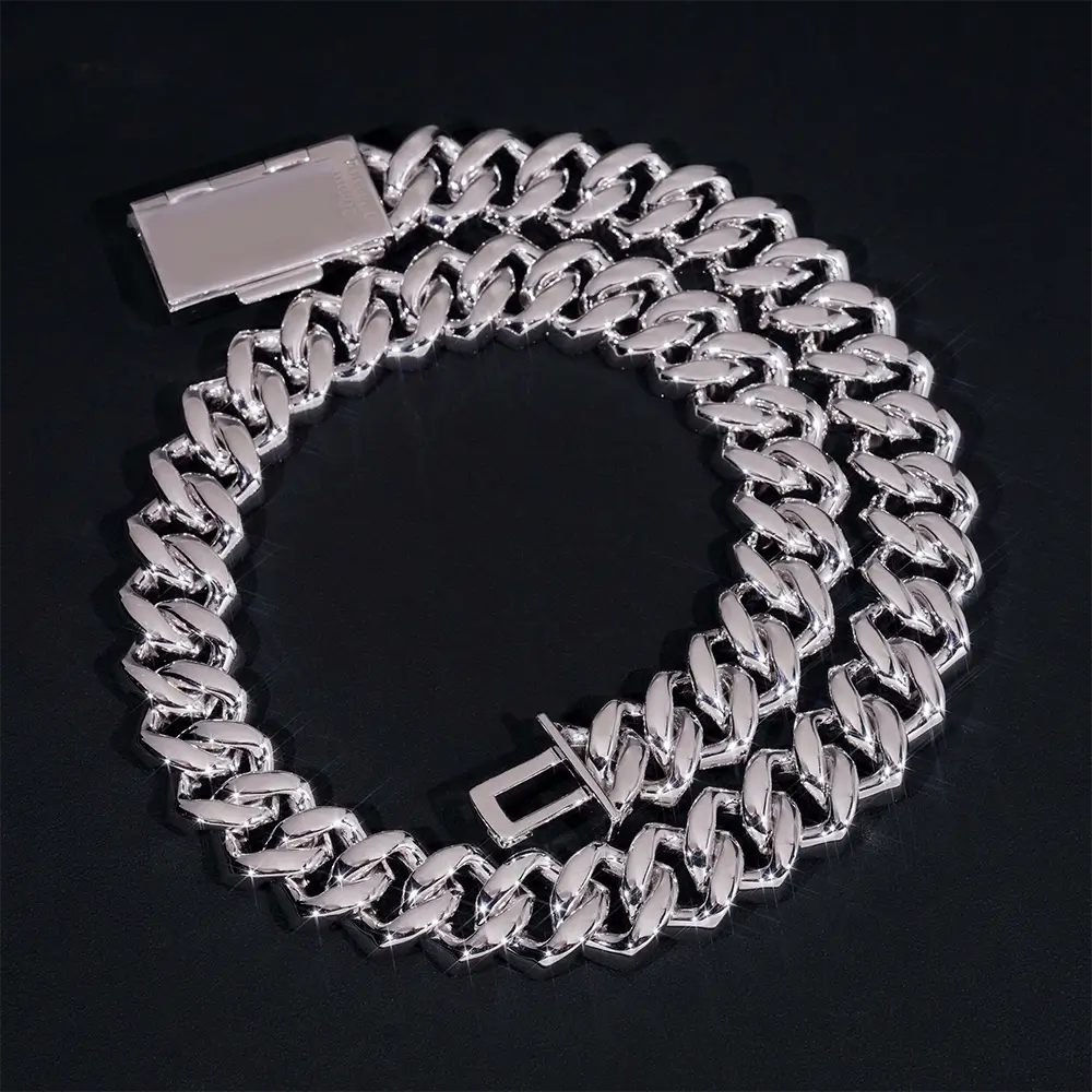 Silver Cuban link chain bracelet with box clasp on black background, luxury jewelry