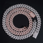 Two iced out Cuban link necklaces, rose gold and silver, with diamond-like stones on black background