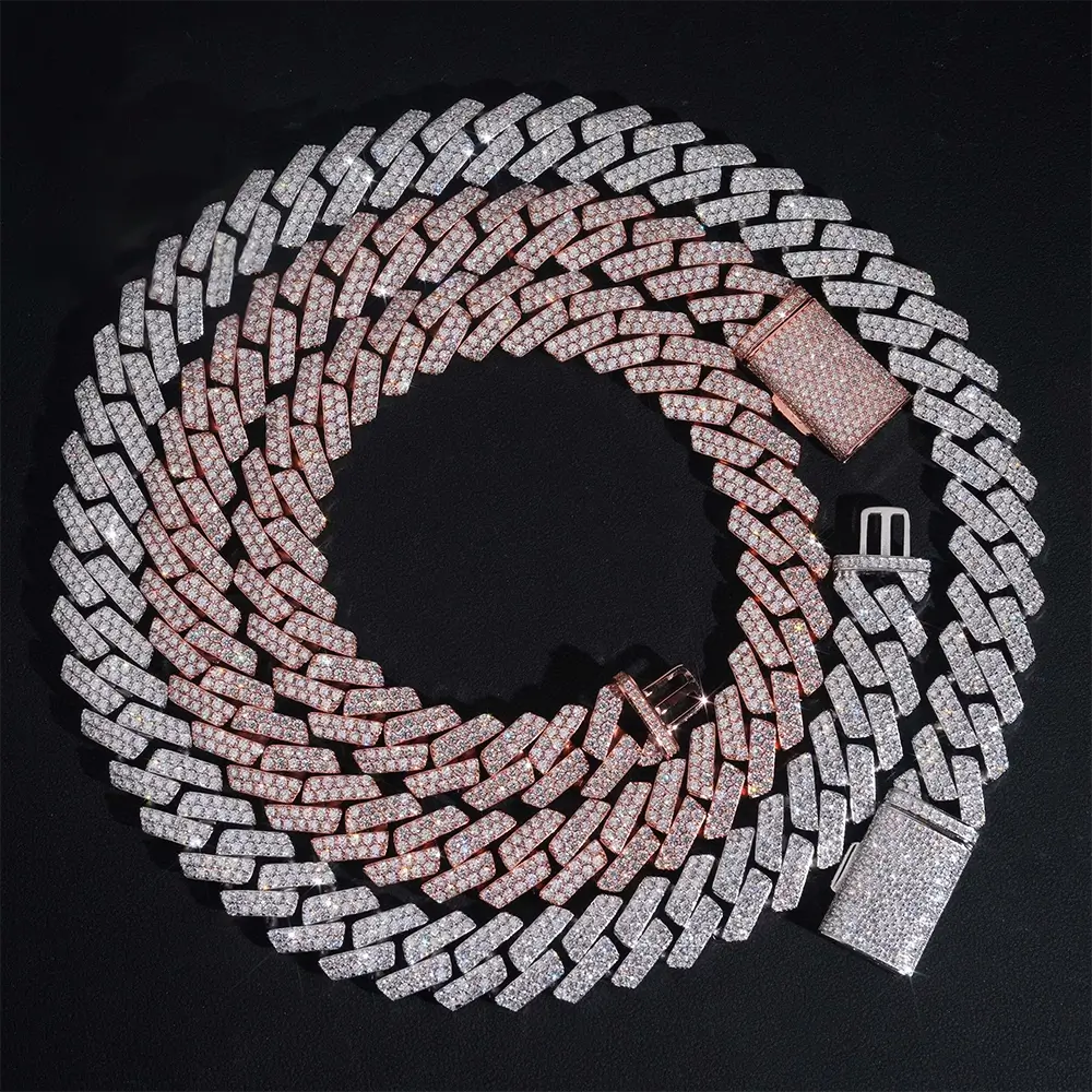 Two iced out Cuban link necklaces, rose gold and silver, with diamond-like stones on black background