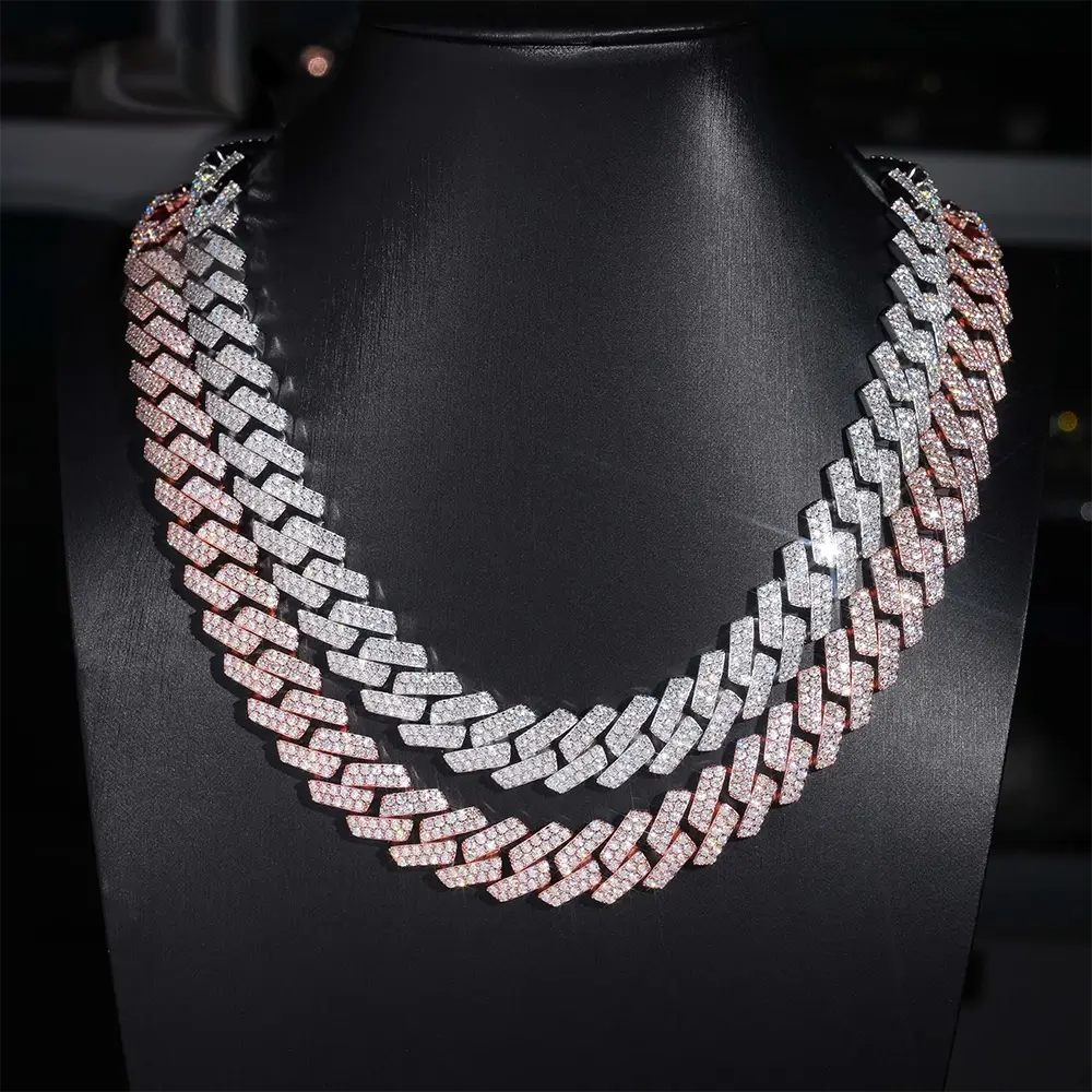Two-tone iced out Cuban link chains with sparkling stones on a black jewelry bust display Secondary image