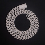 Iced out Cuban link chain necklace with sparkling stones on black background