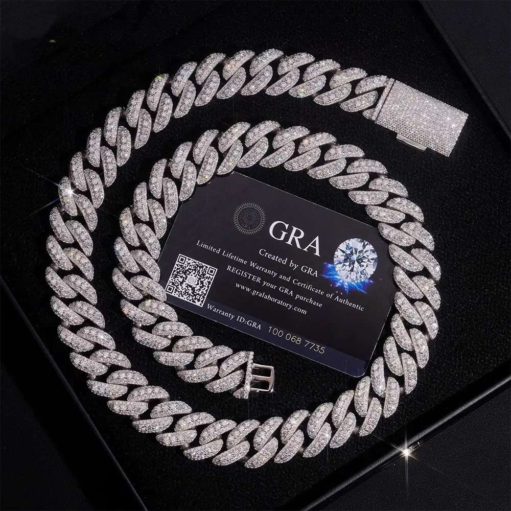 Iced out Cuban link chain necklace with sparkling diamonds, displayed in a jewelry box.