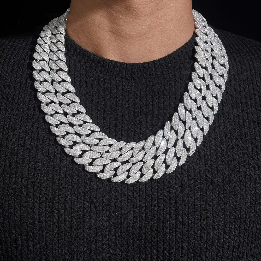 Layered iced-out Cuban link chain necklace with sparkling stones on black shirt Main image