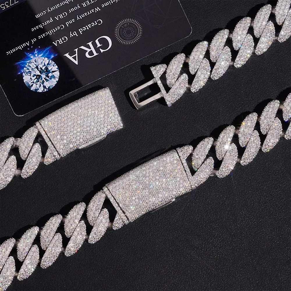 close-up of iced-out Cuban link chain with clasp, pavé stones on black background
