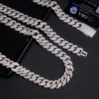 Iced out Cuban link chain necklace and bracelet set with diamonds on black surface