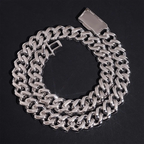 Thick silver Cuban link chain necklace with polished finish on black background