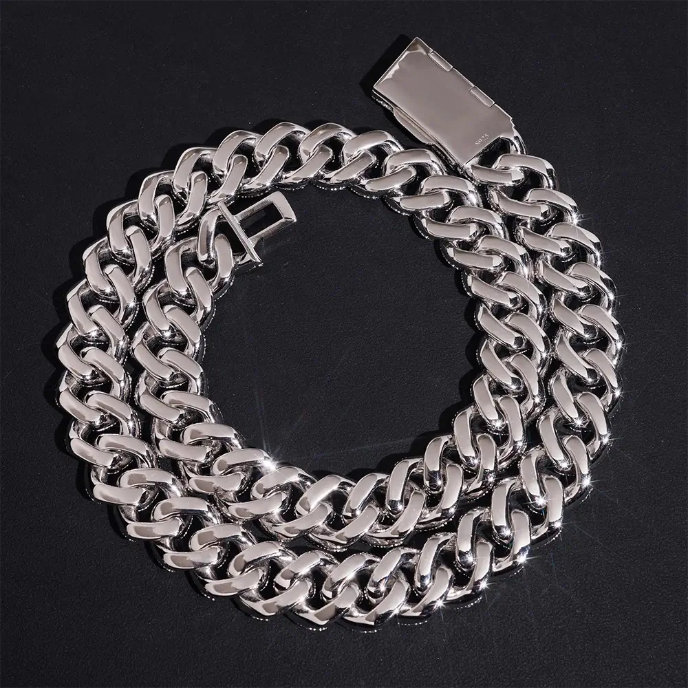 Thick silver Cuban link chain necklace with polished finish on black background