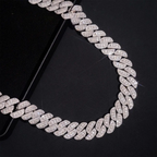 Cuban link chain necklace with sparkling pavé stones on a black background