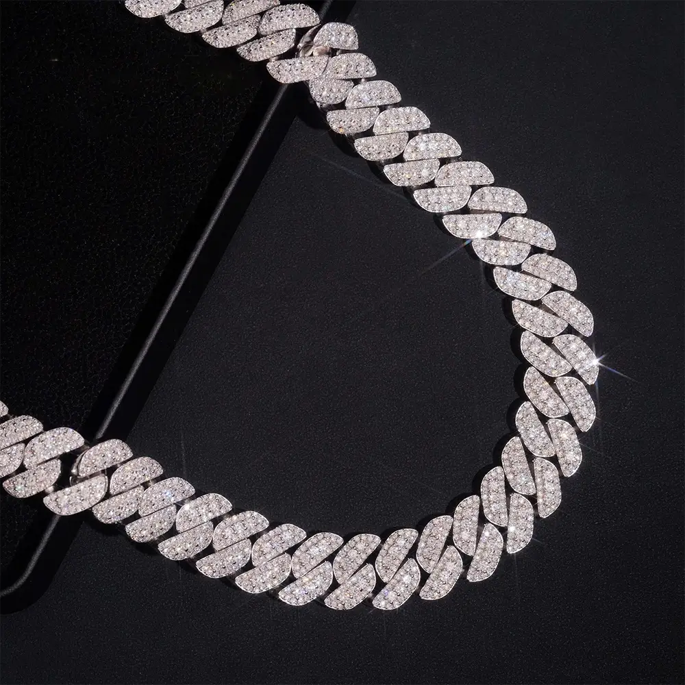 Cuban link chain necklace with sparkling pavé stones on a black background