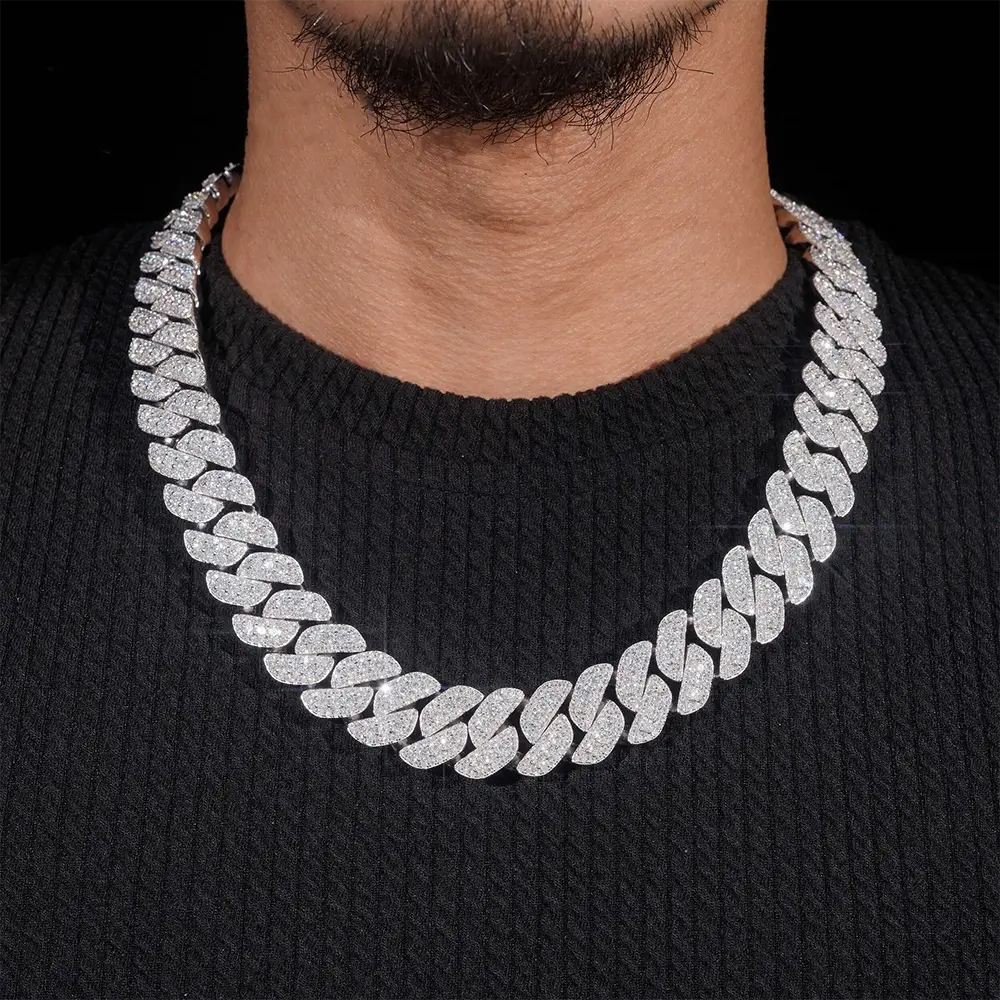 close up of iced out cuban link chain necklace on man wearing black sweater Main image