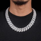 close up of iced out cuban link chain necklace on man wearing black sweater