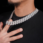 Close-up of man wearing a thick iced out Cuban link chain necklace with diamonds