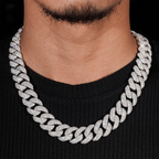 Close-up of man wearing a thick iced out Cuban link chain necklace