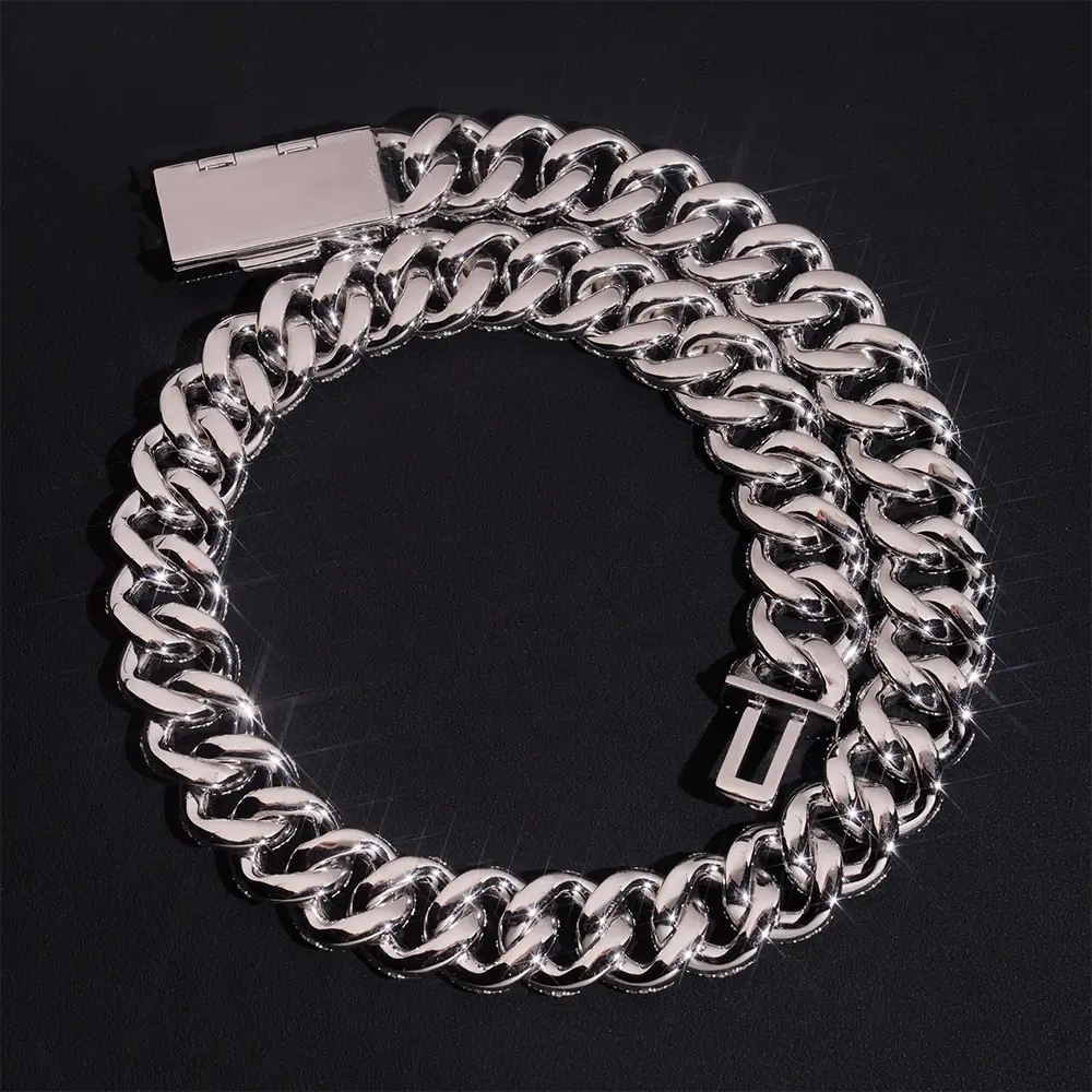 Shiny silver Cuban link chain necklace with box clasp on black background