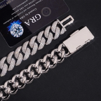 Silver Cuban link bracelets, one iced with diamonds, on black background with certification card