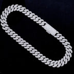 Iced out Cuban link chain necklace with pavé stones on black background