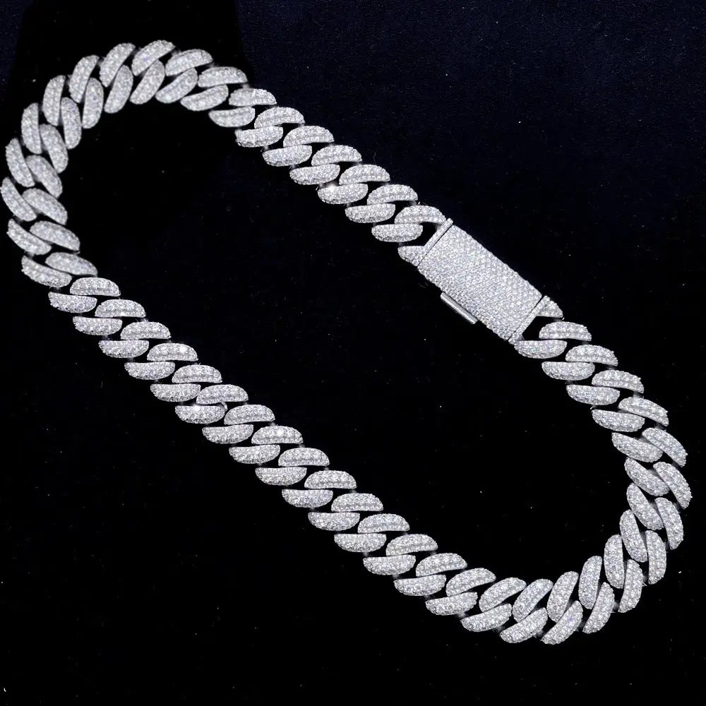 Iced out Cuban link chain necklace with pavé stones on black background