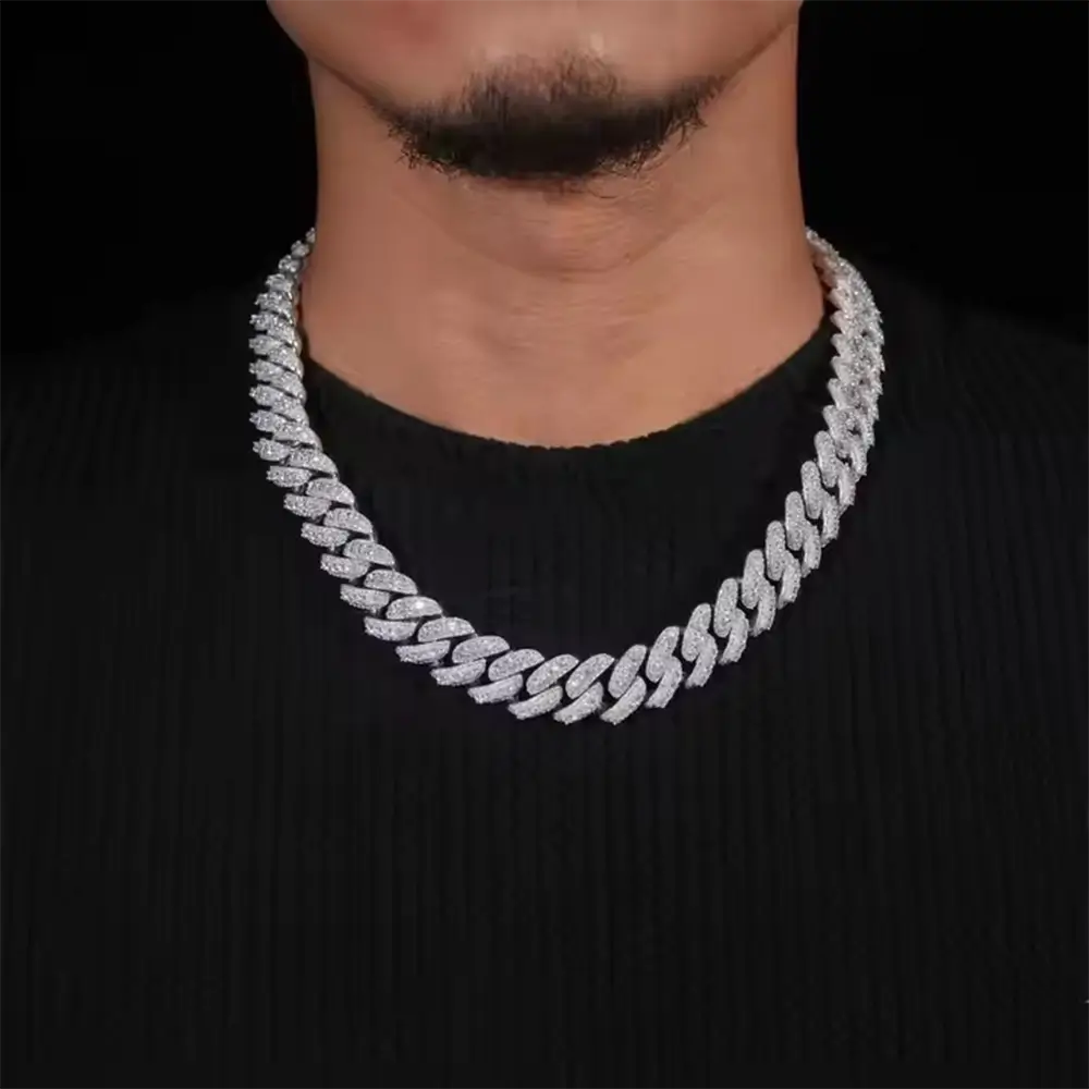 Man wearing a thick iced out Cuban link chain necklace over a black shirt Main image