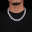Man wearing a thick iced out Cuban link chain necklace over a black shirt