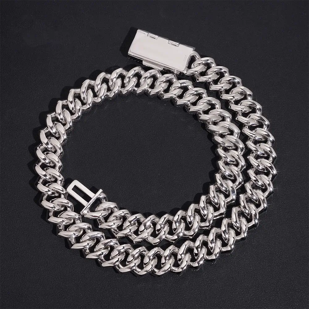 Silver Cuban link chain bracelet with box clasp on black background