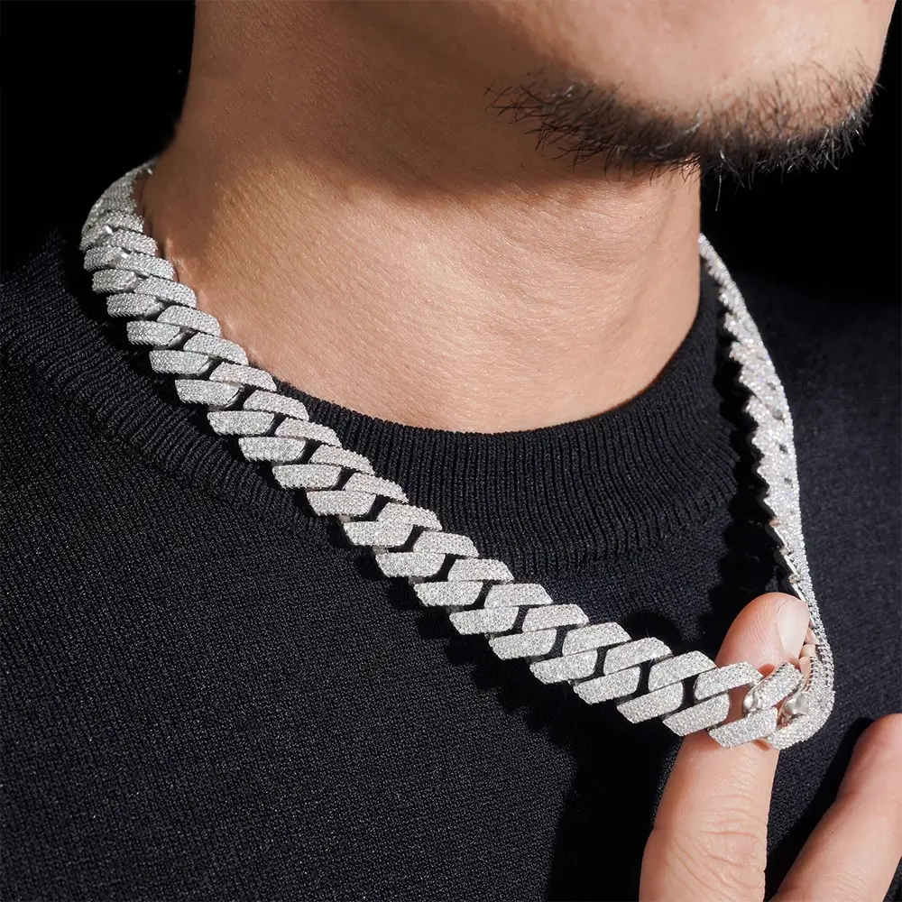 Close-up of a man wearing a thick iced-out Cuban link chain necklace Main image
