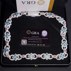 Luxury diamond necklace with blue and pink gemstone accents in black jewelry box