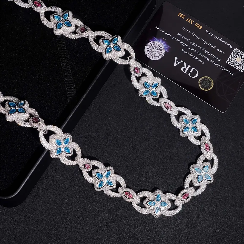 Luxury silver necklace with blue and pink gemstones in floral and oval designs on black background