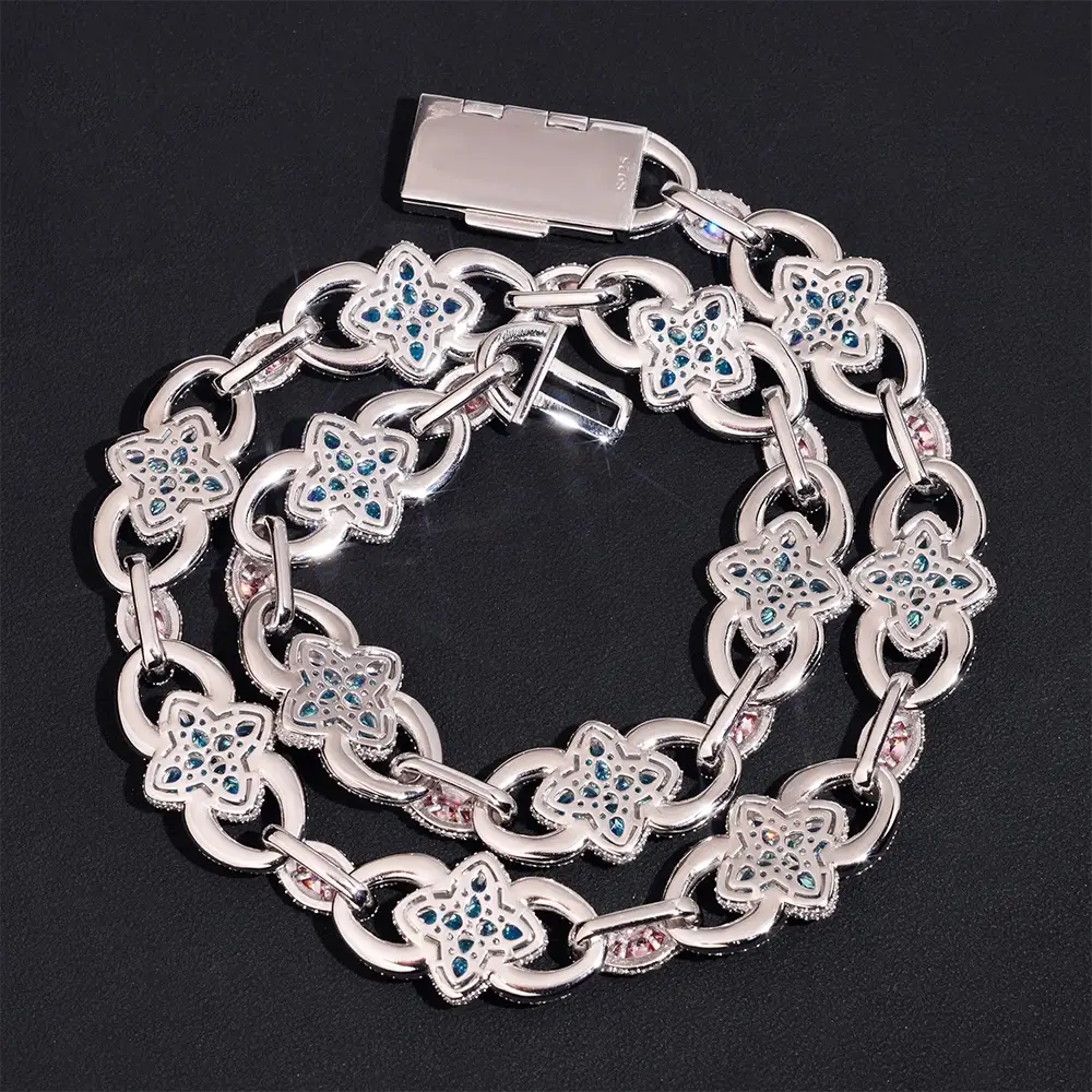 Silver chain necklace with blue gemstone floral links on black background
