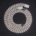 Iced out Cuban link chain necklace with sparkling pavé stones on black background