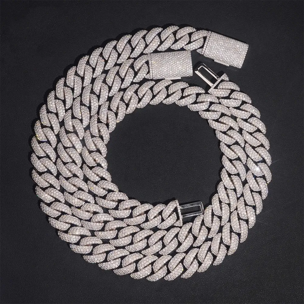 Iced out Cuban link chain necklace with sparkling pavé stones on black background