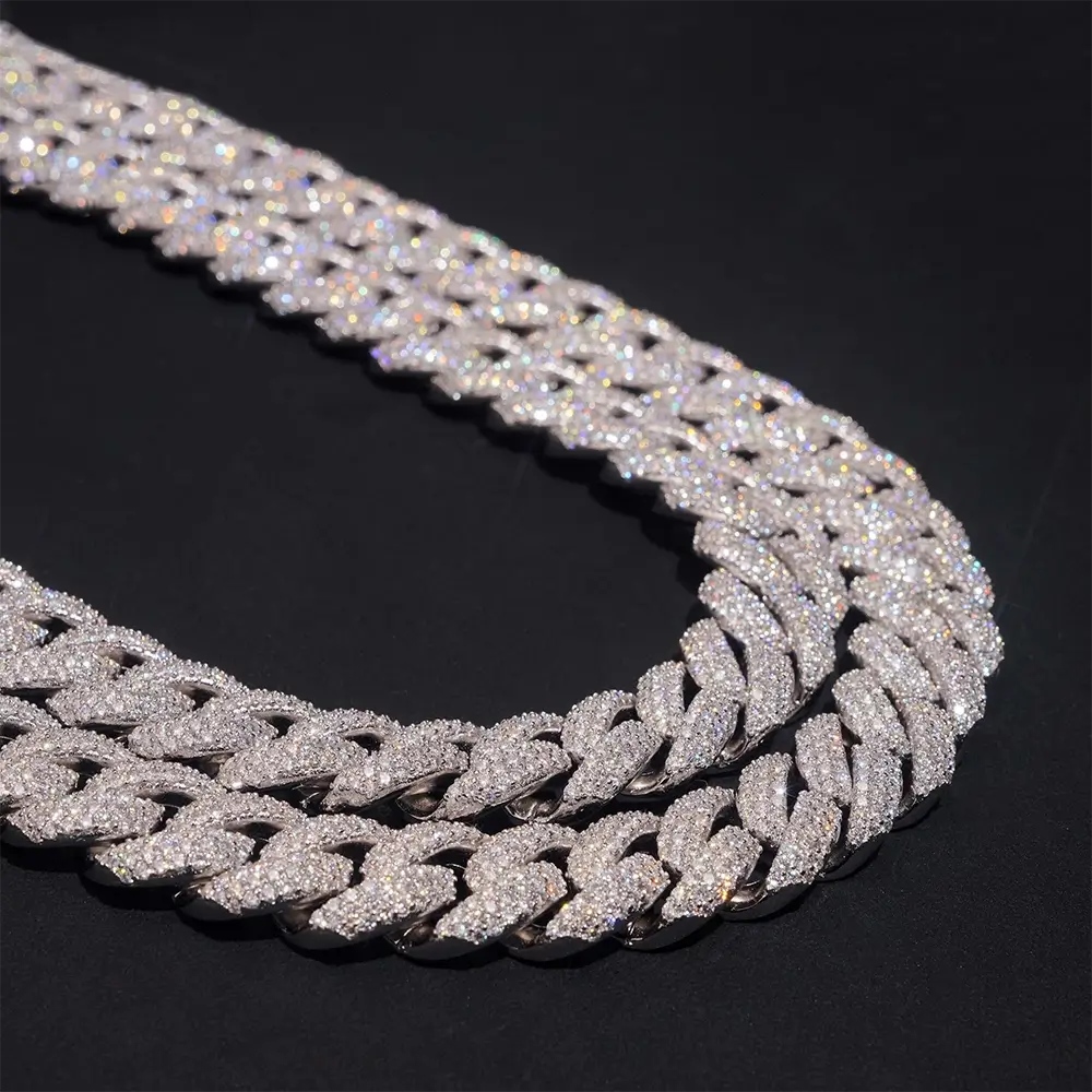 Iced out Cuban link chain necklace with sparkling stones on a black background