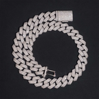 Iced out Cuban link chain necklace with sparkling stones on a black background