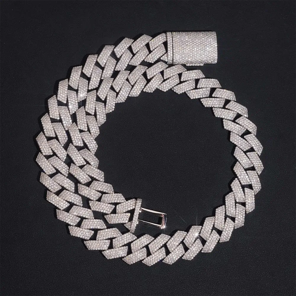 Iced out Cuban link chain necklace with sparkling stones on a black background
