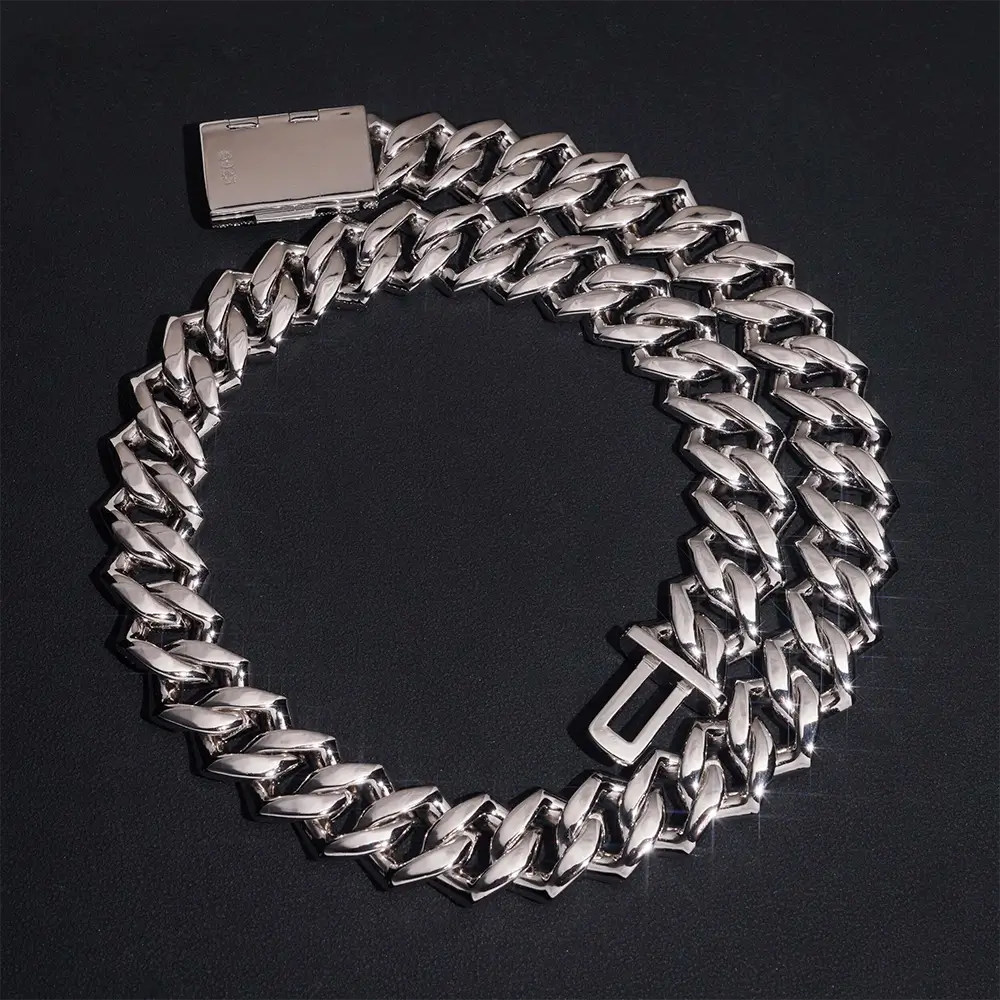 Chunky silver Cuban link chain necklace with box clasp on black background