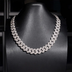 Iced out Cuban link chain necklace with clear stones on a black display bust
